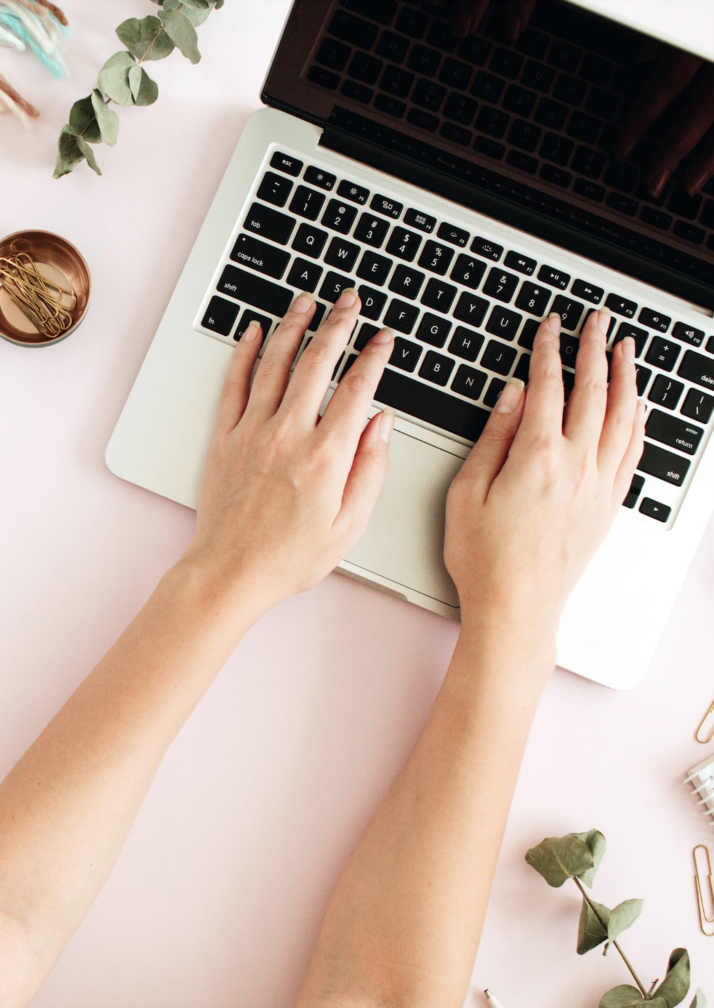 woman typing on apple MacBook 